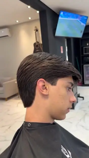 Jovem de perfil com corte clássico e capa da Lottus